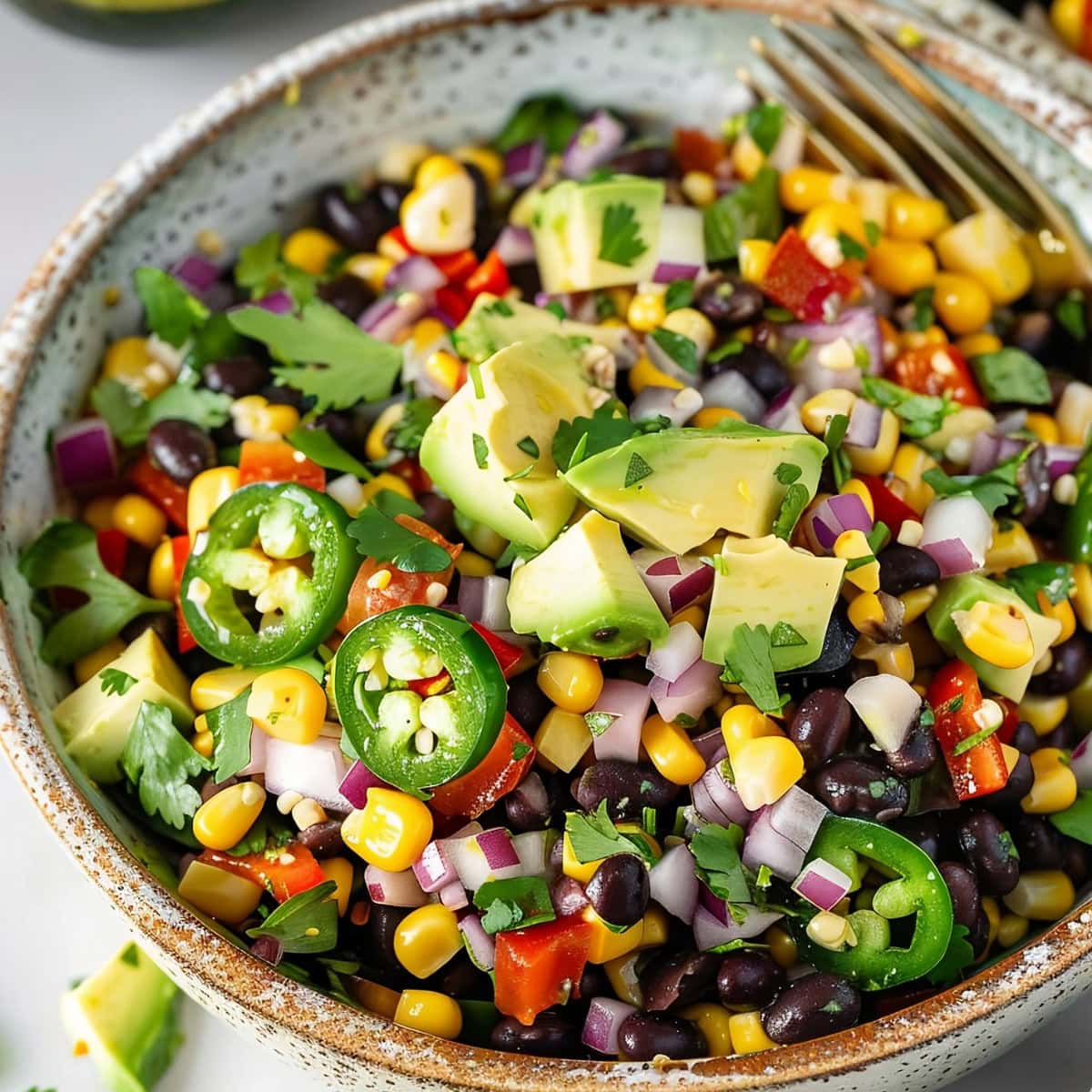 Colorful black bean and corn salad, garnished with cilantro.