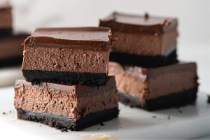 Chocolate Cheesecake Bars slices in a cake tray.