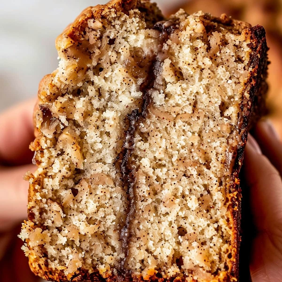 A Hand Holding a Cinnamon Crunch Banana Bread.