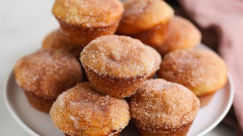 Bunch of donut muffins in a white plate.