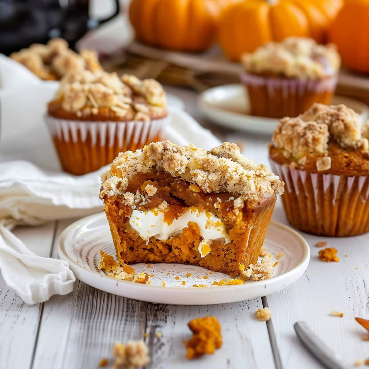 Pumpkin Cream Cheese Muffins with Streusel topping On A Plate