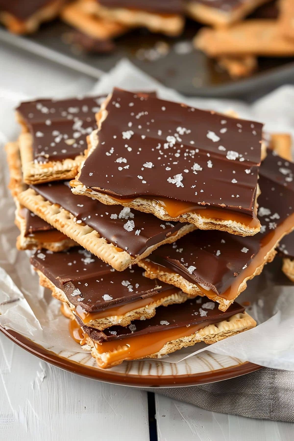 Sweet and salty saltine cracker toffee, served in a rustic bowl with extra chocolate chips.