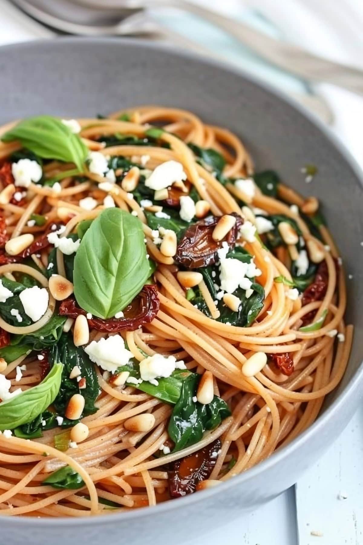 Spaghetti with Sun Dried Tomatoes and Spinach in a Bowl.