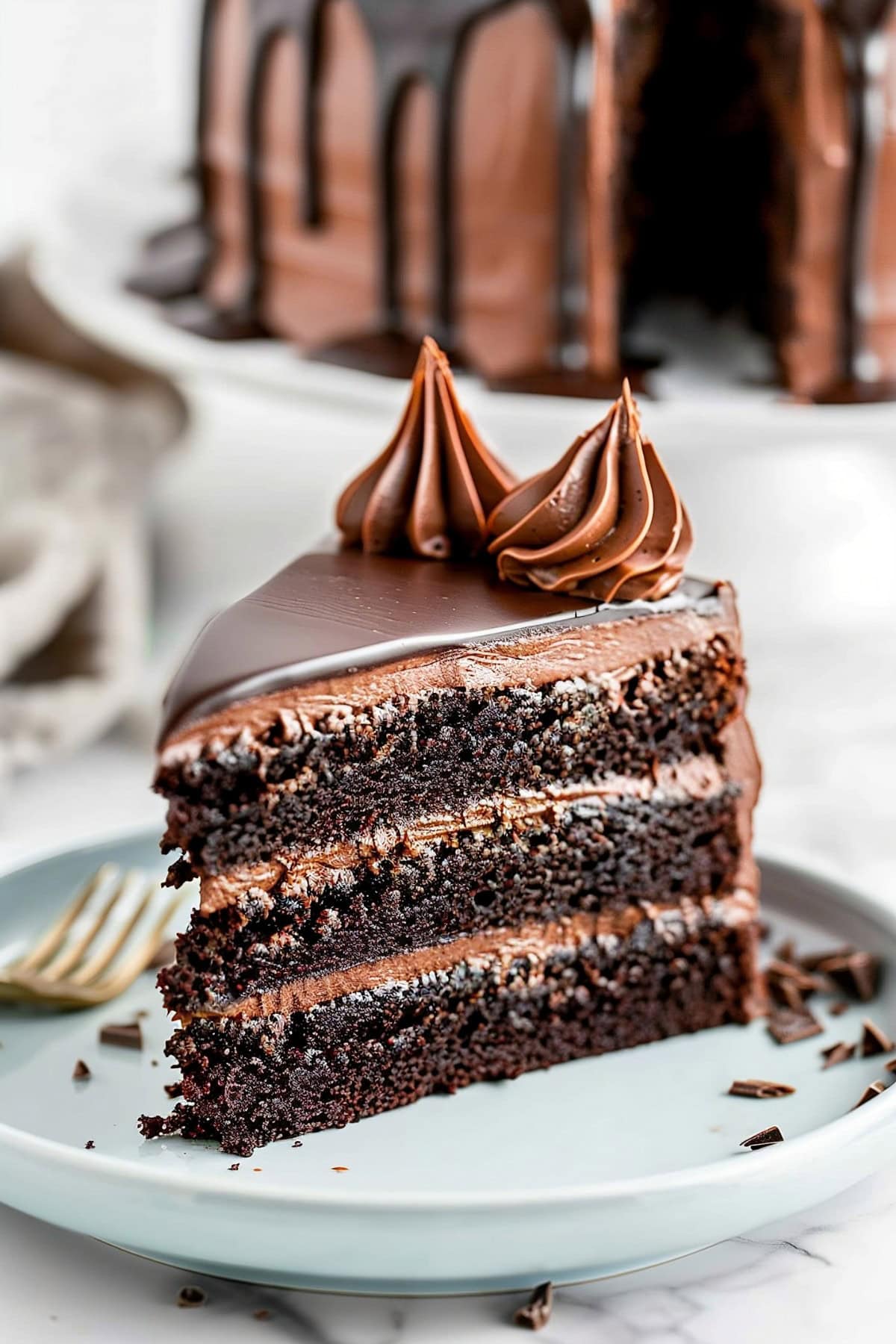 Triple chocolate cake slice on a plate