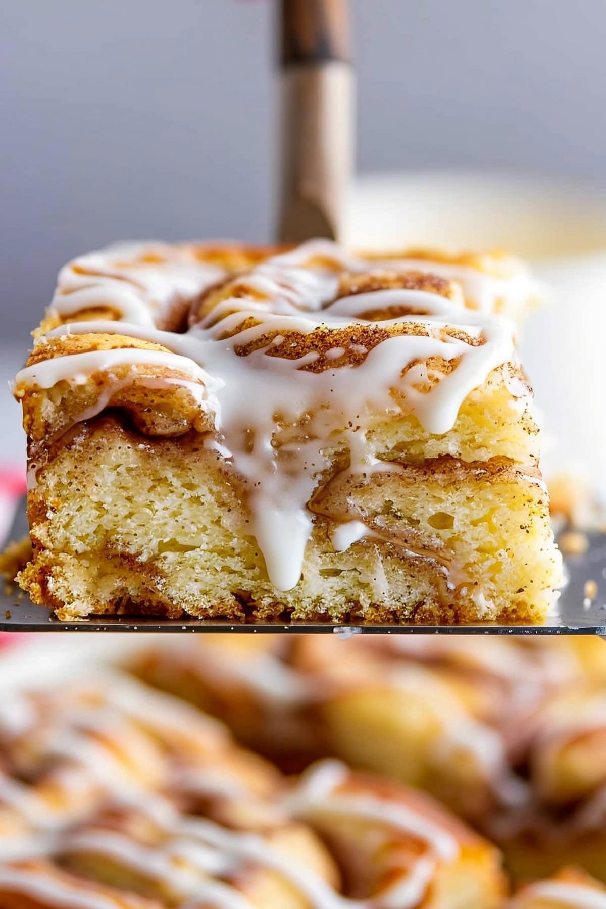 Soft and fluffy vanilla sheet cake with swirls of cinnamon sugar and vanilla glaze on top, close up