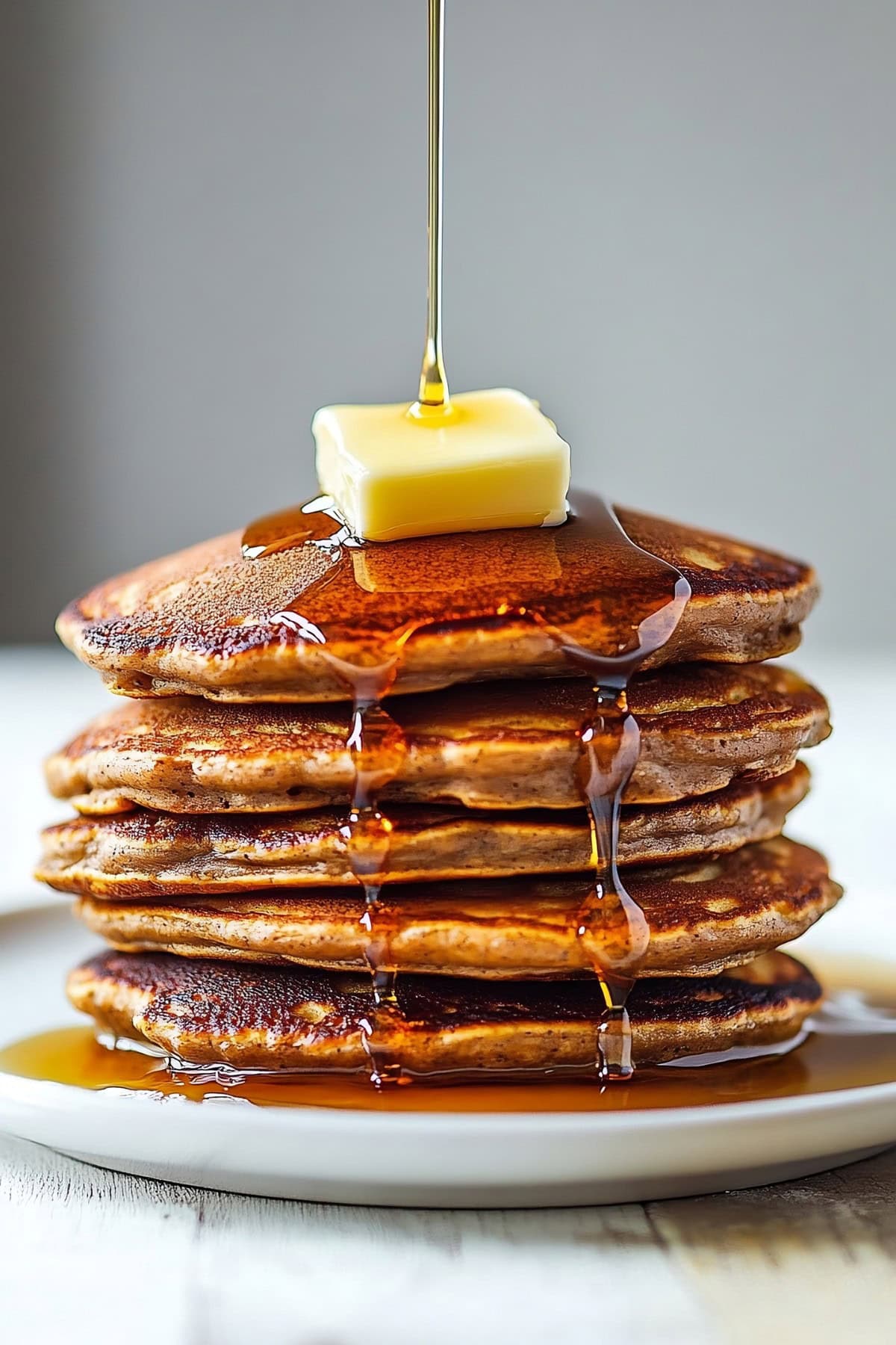 Warm gingerbread pancakes drizzled with maple syrup.