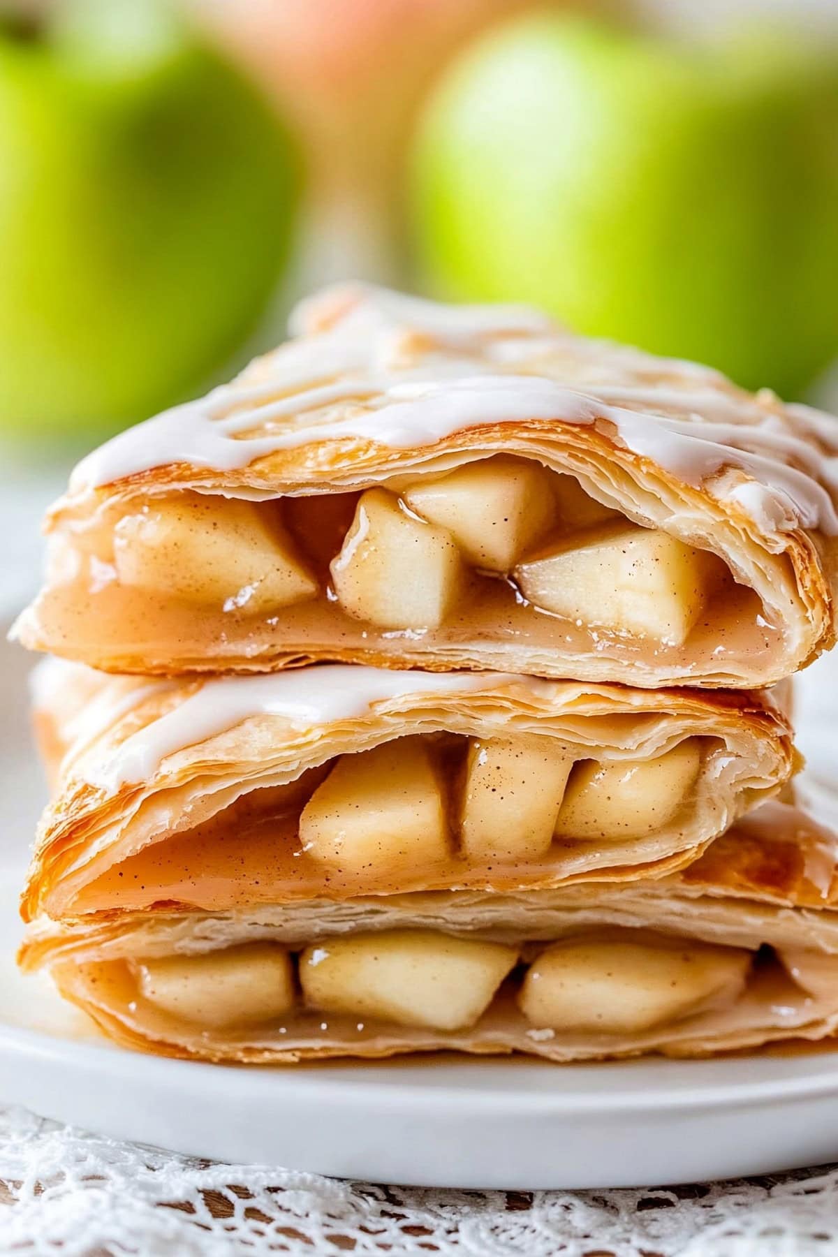 Delicious apple turnovers cut in half and stacked to show the flaky pastry and juicy filling