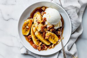 Bananas Foster with perfectly caramelized banana slices and a rich, buttery rum sauce poured over vanilla ice cream.