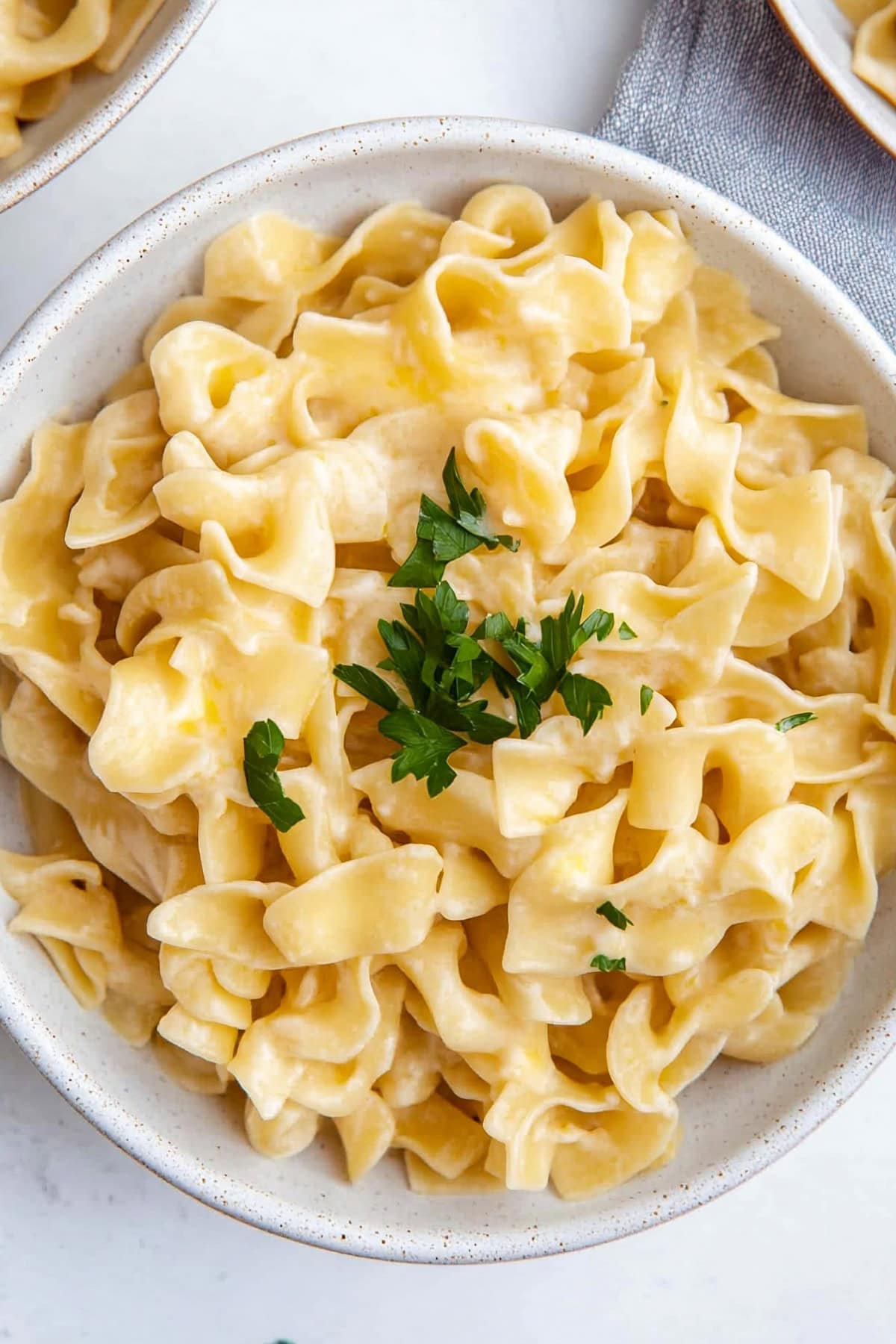 A serving of cafeteria noodles with a light gravy sauce, ready to be enjoyed.