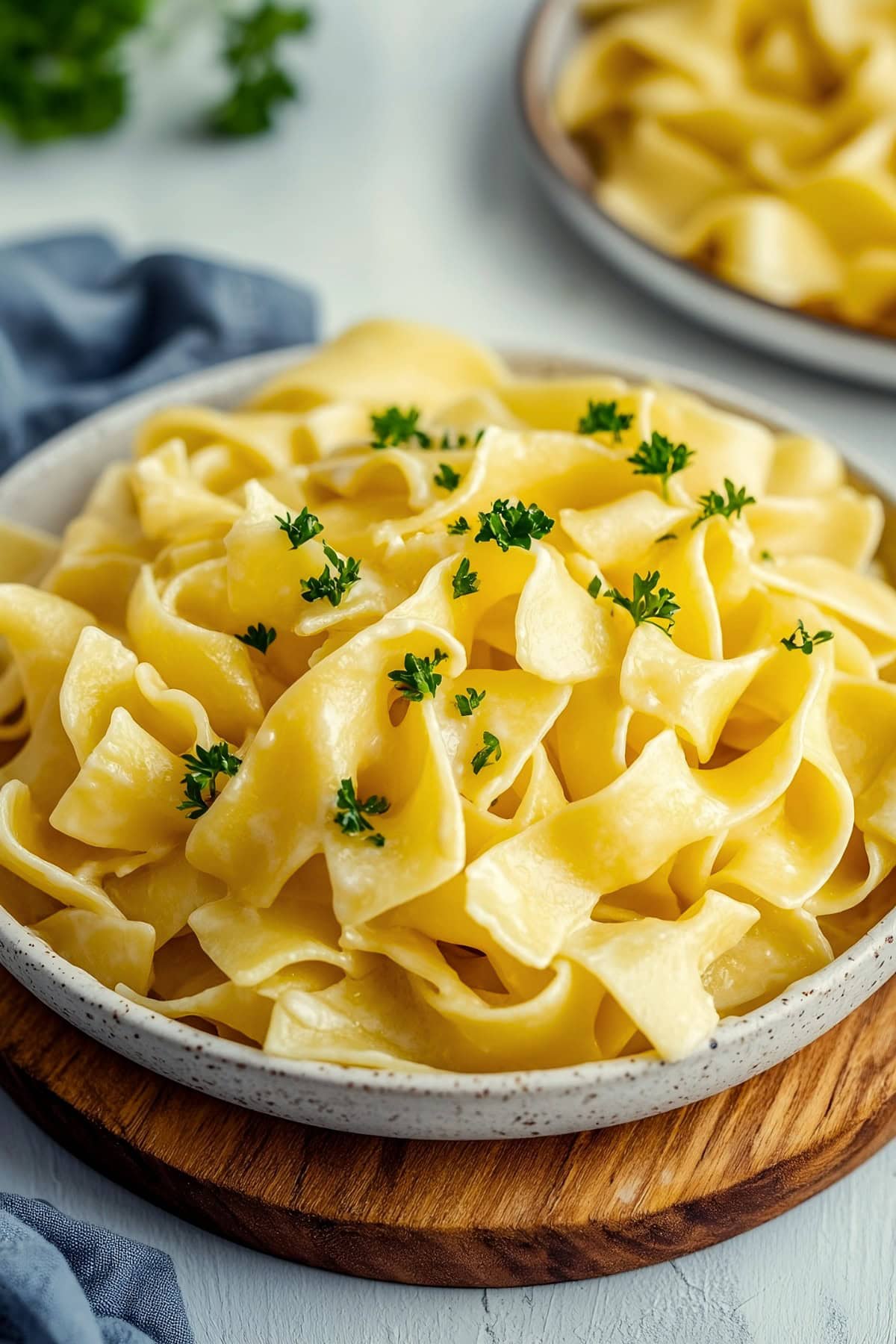 Creamy homemade cafeteria noodles garnished with parsley.