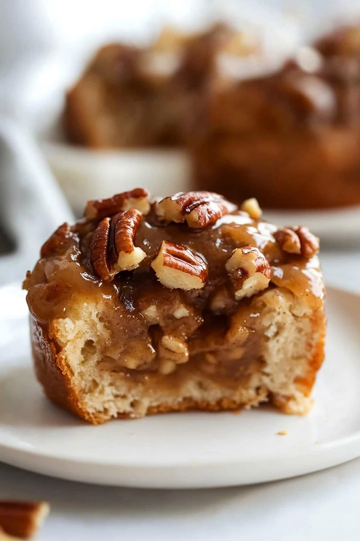 Close-up of gooey caramel pecan sticky bun fresh out of the oven.