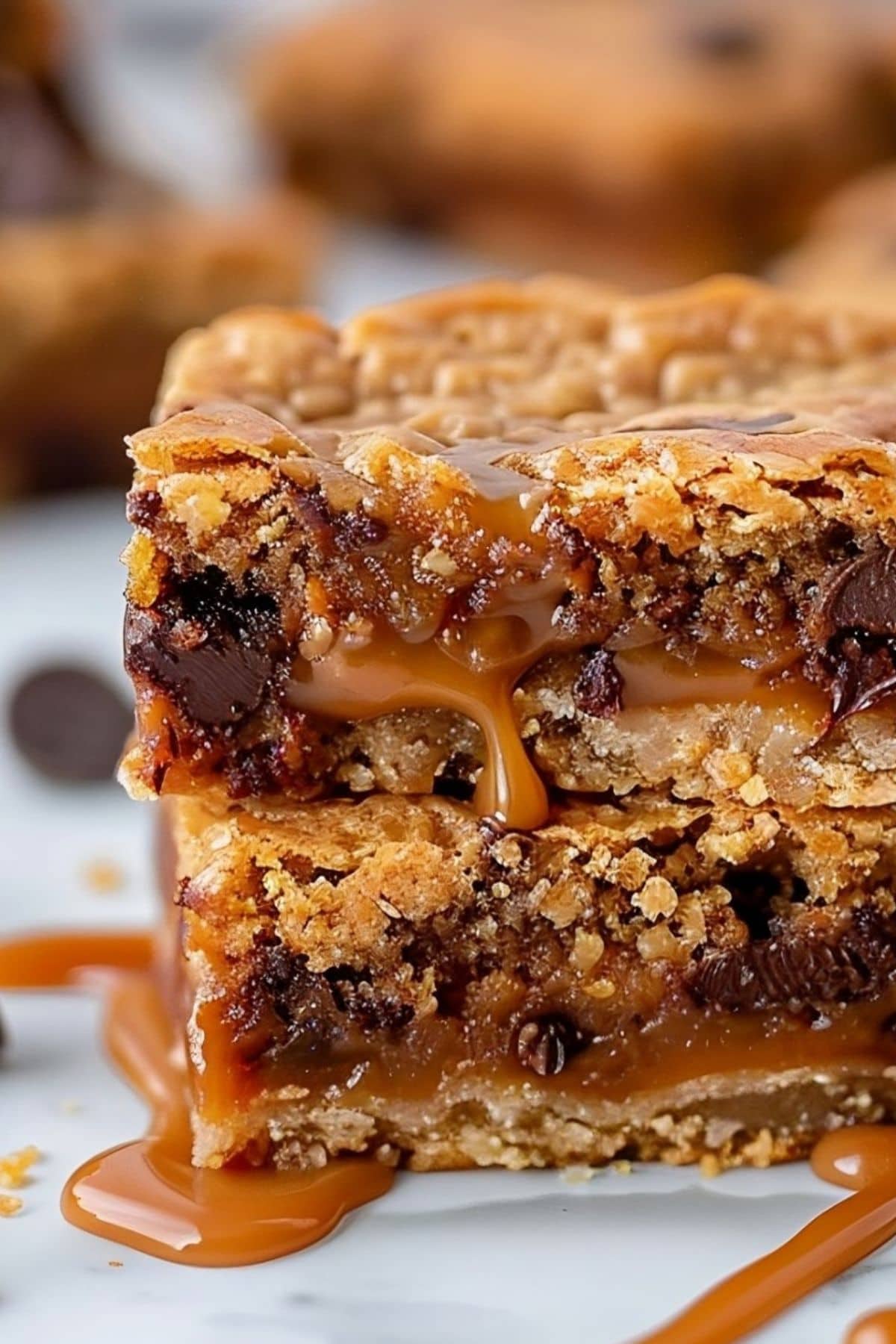 Square slices of carmelitas bars with gooey caramel, chocolate chips and buttery oat crust.