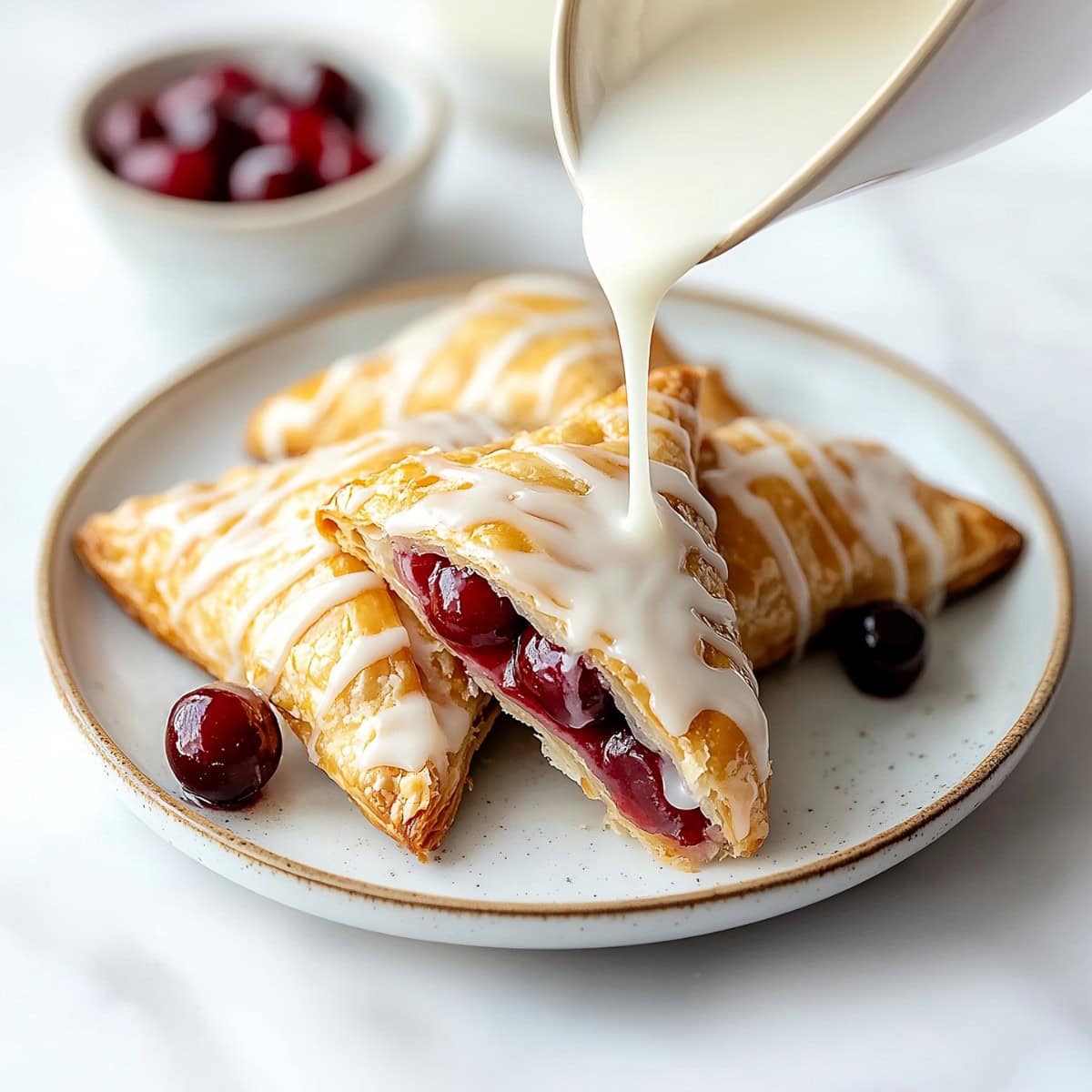 Crispy cherry turnovers with a drizzle of icing.