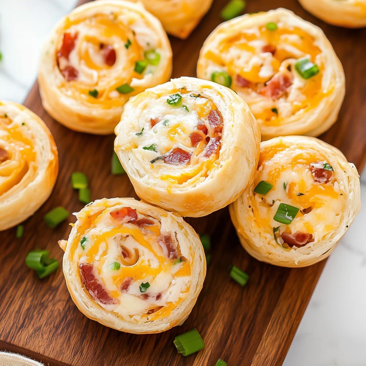 A stack of chicken bacon ranch pinwheels with visible swirls of chicken, bacon, and ranch dressing.