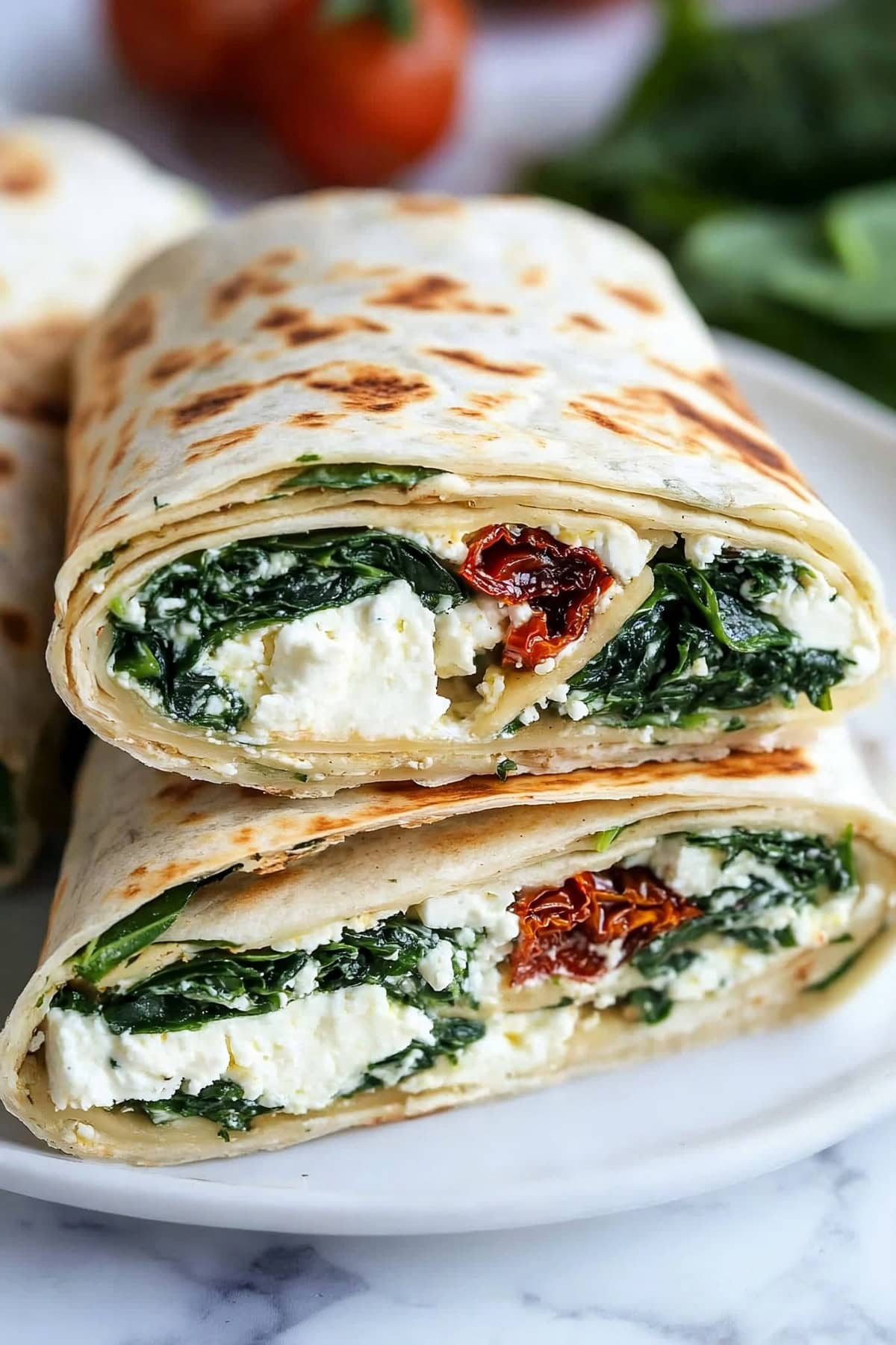 Warm and toasty copycat Starbucks spinach feta wrap on a white plate.