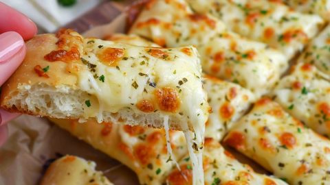 Delicious Italian Cheese Bread topped with a blend of cheeses and herbs.