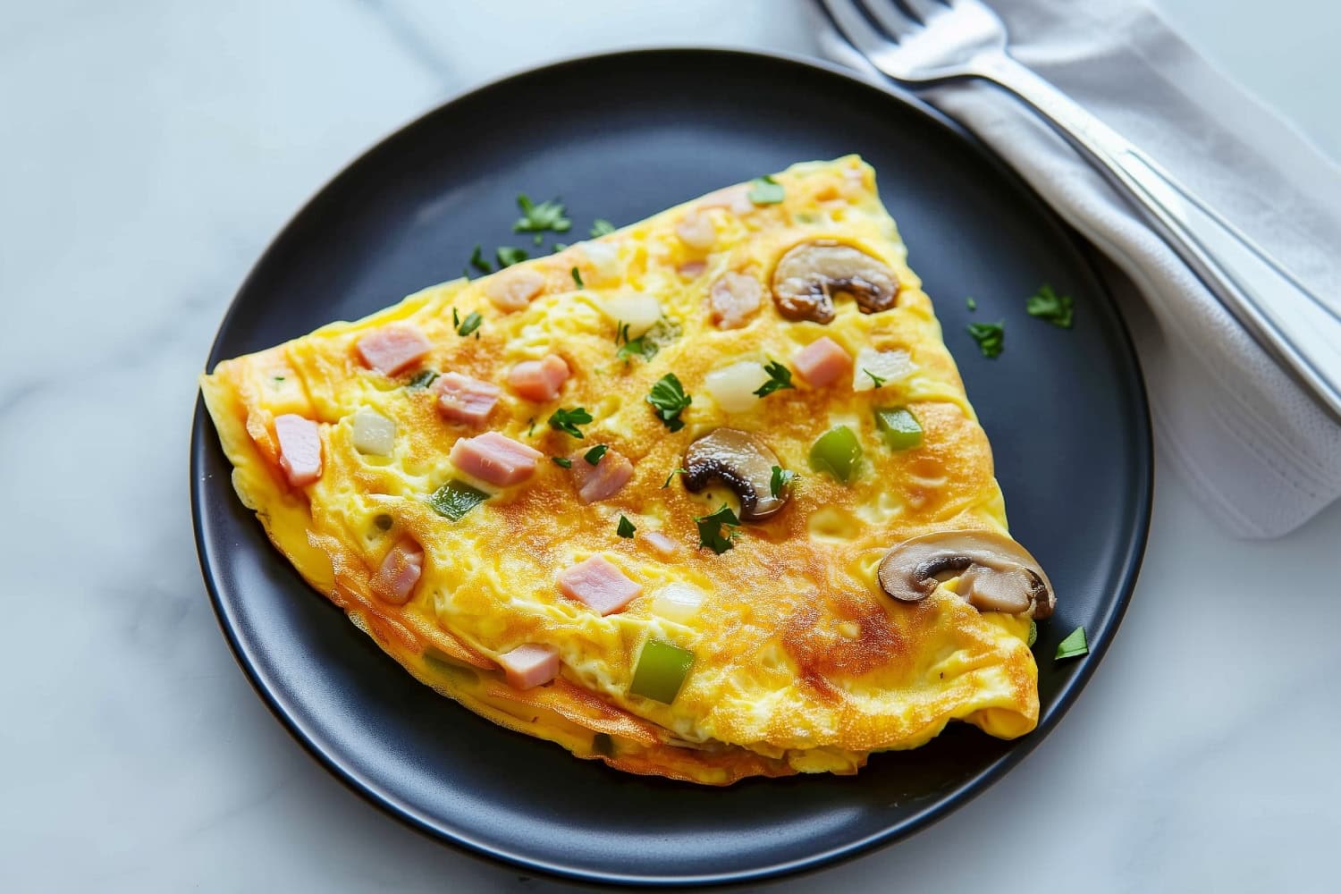 A Denver omelette with slight crispy edges and gooey cheese filling.