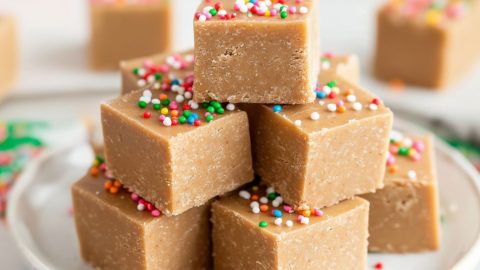 Bunch of cube slices of gingerbread fudge arranged in a white plate.