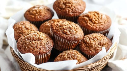 A basket filled with freshly baked gingerbread muffins, perfect for the holidays.