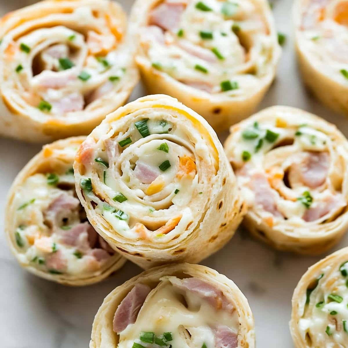 Savory ham and cheese pinwheels with golden, flaky pastry spirals.