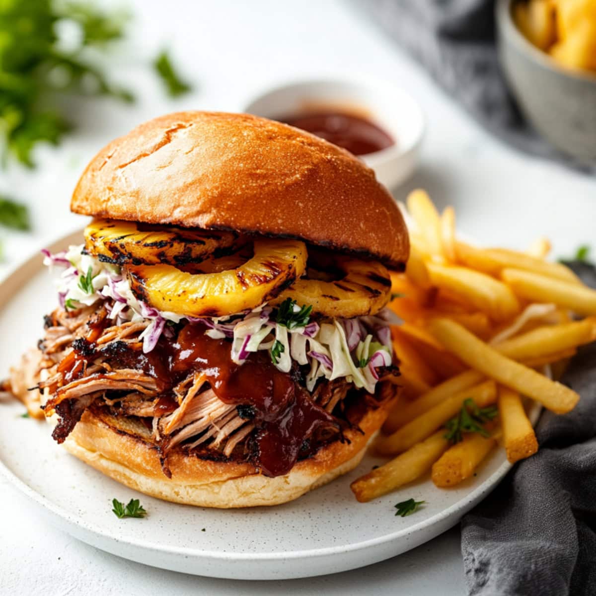 Pulled pork sandwich served with fries and barbeque sauce.