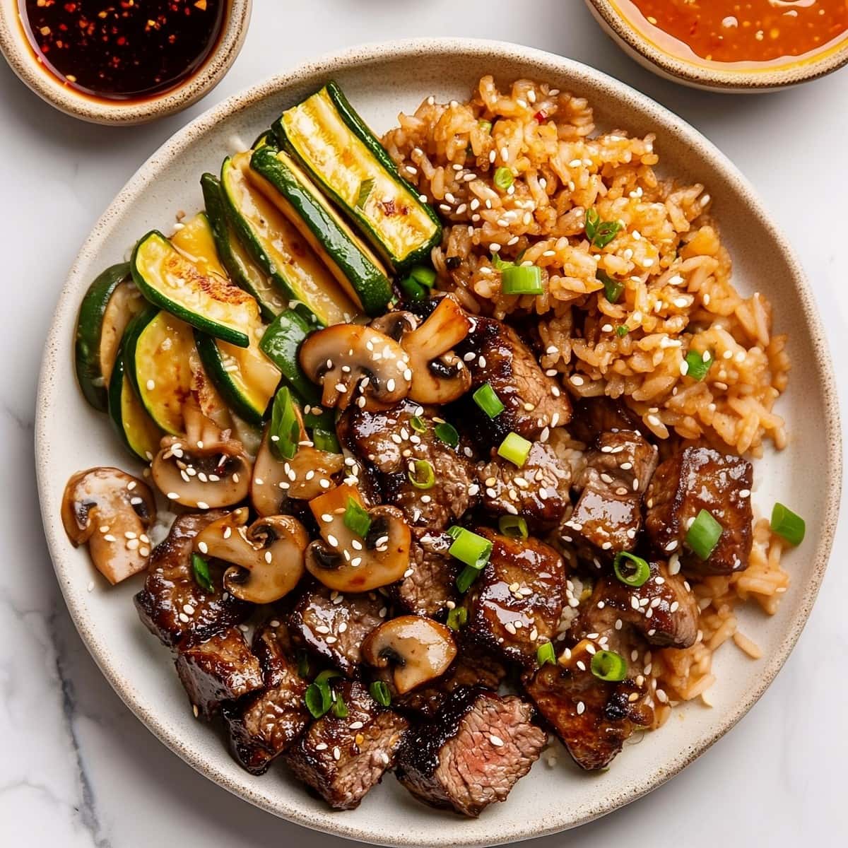 Homemade copycat Hibachi steak with zucchini, mushrooms, and served with rice.