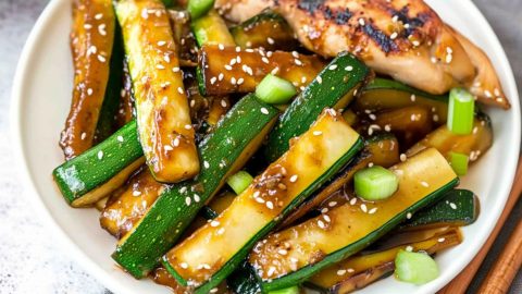 Hibachi zucchini tossed in sauce garnished with sesame seeds.