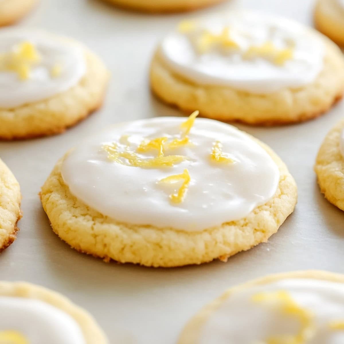 Lemon sugar cookies with lemon glaze and zest, close up