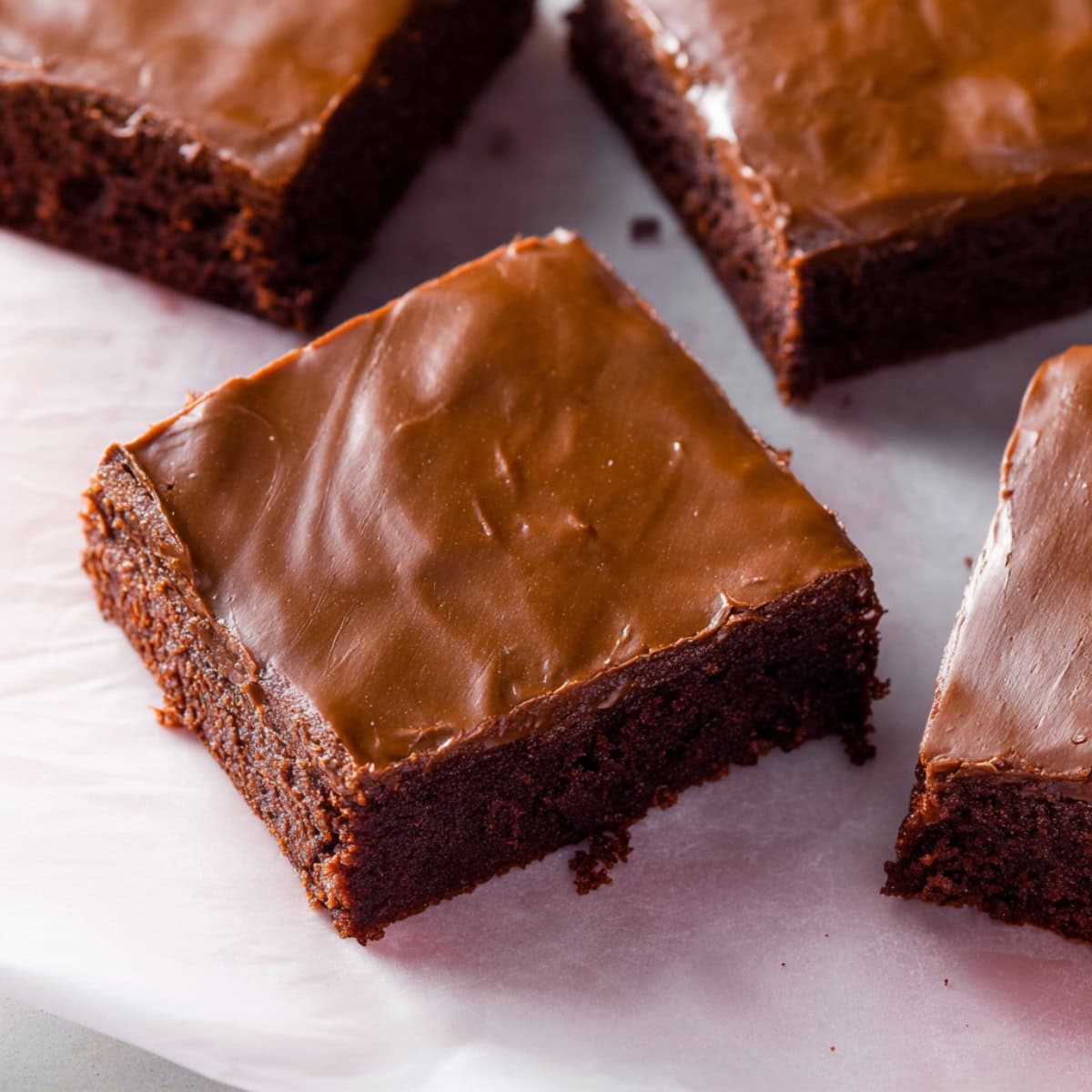 A close-up shot of lunch lady brownies with chocolate frosting topping.