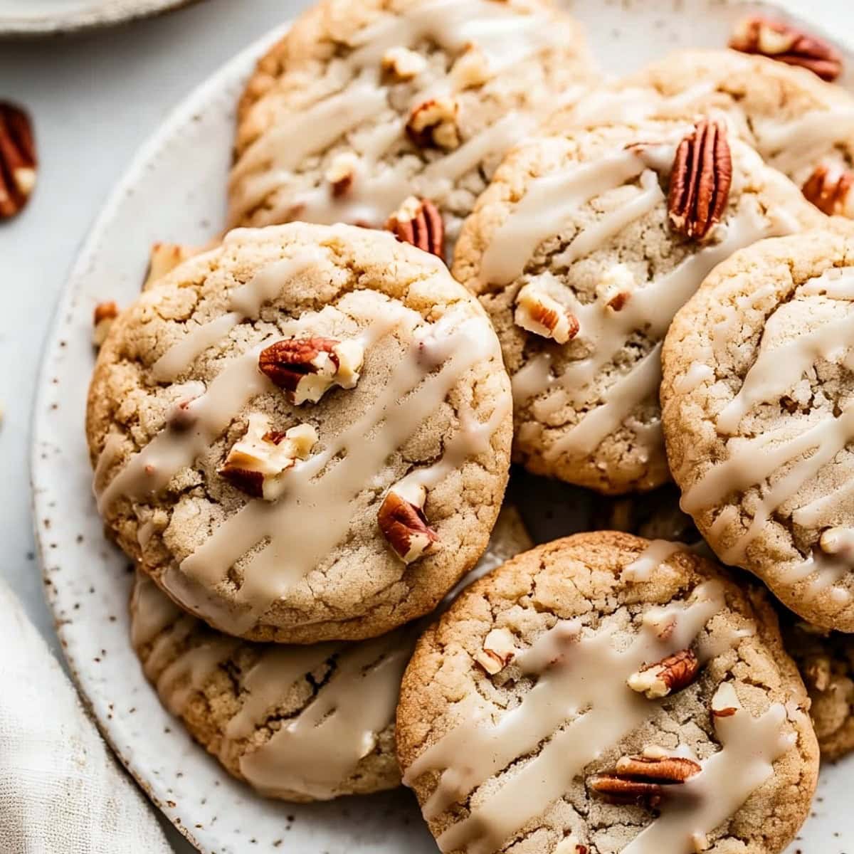 Maple cookies with maple icing in a plate, overhead view.