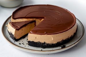 Homemade peanut butter cheesecake with a crunchy Oreo crust.