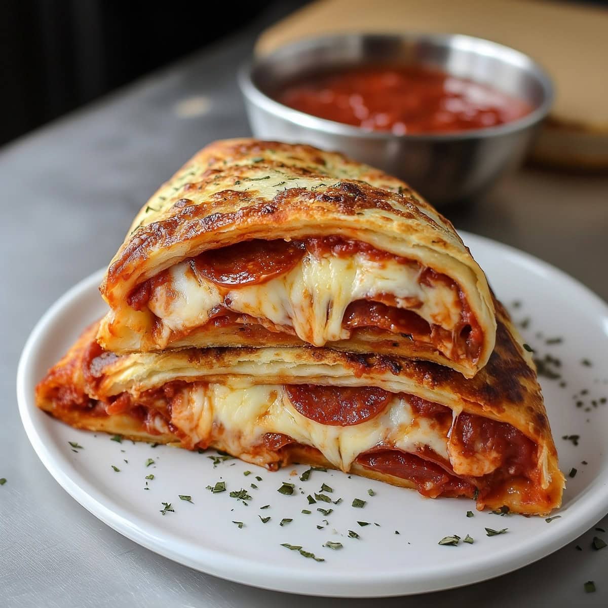 Golden-brown pepperoni stromboli with melted cheese oozing out.