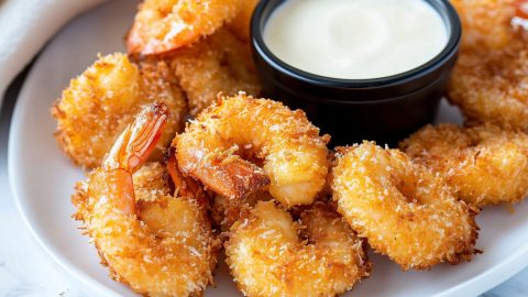 Golden-brown copycat Red Lobster coconut shrimp on a white plate.