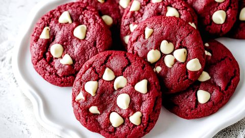 A plate of red velvet white chocolate chip cookies, ready to be served.