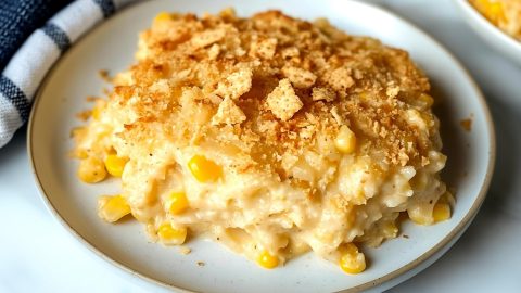 A close-up of the crunchy breadcrumb topping on a dish of scalloped corn, ready to be served.