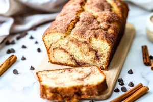 Sliced snickerdoodle bread load on a wooden board.