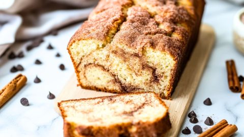 Sliced snickerdoodle bread load on a wooden board.