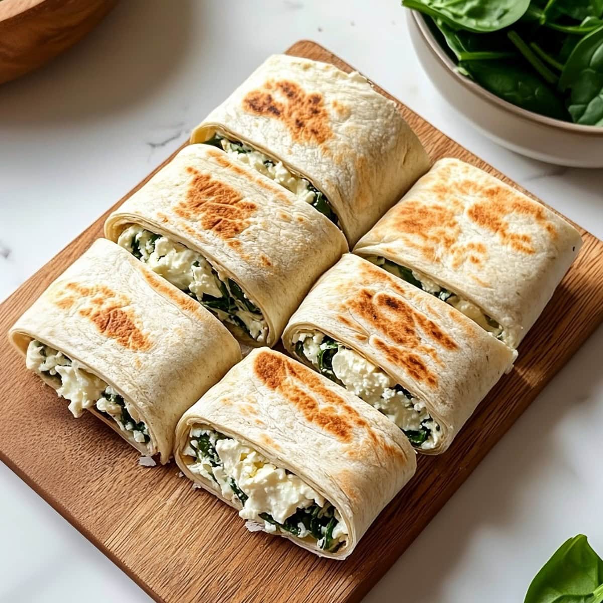 Savory spinach feta wrap with sun-dried tomatoes and a creamy filling.