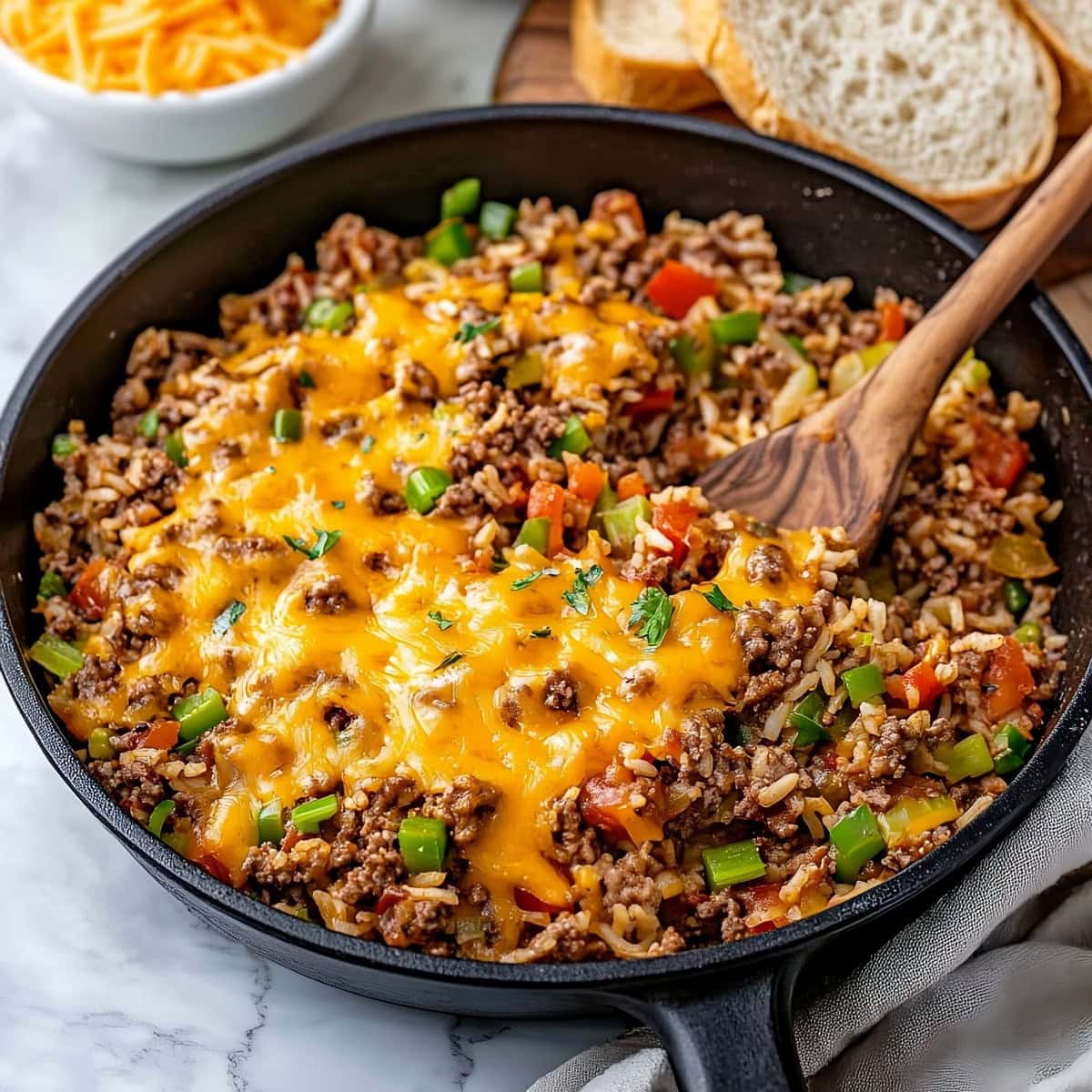 Texas hash served in a skillet, featuring ground beef, rice, and diced tomatoes.