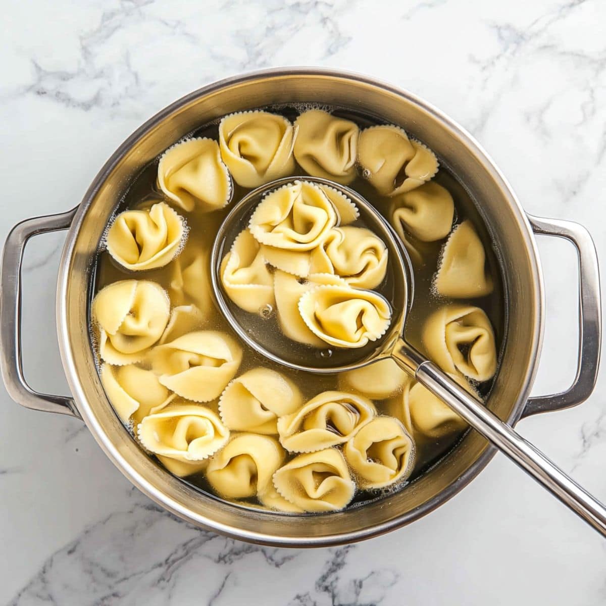 Boiled tortellini pasta in a pot.