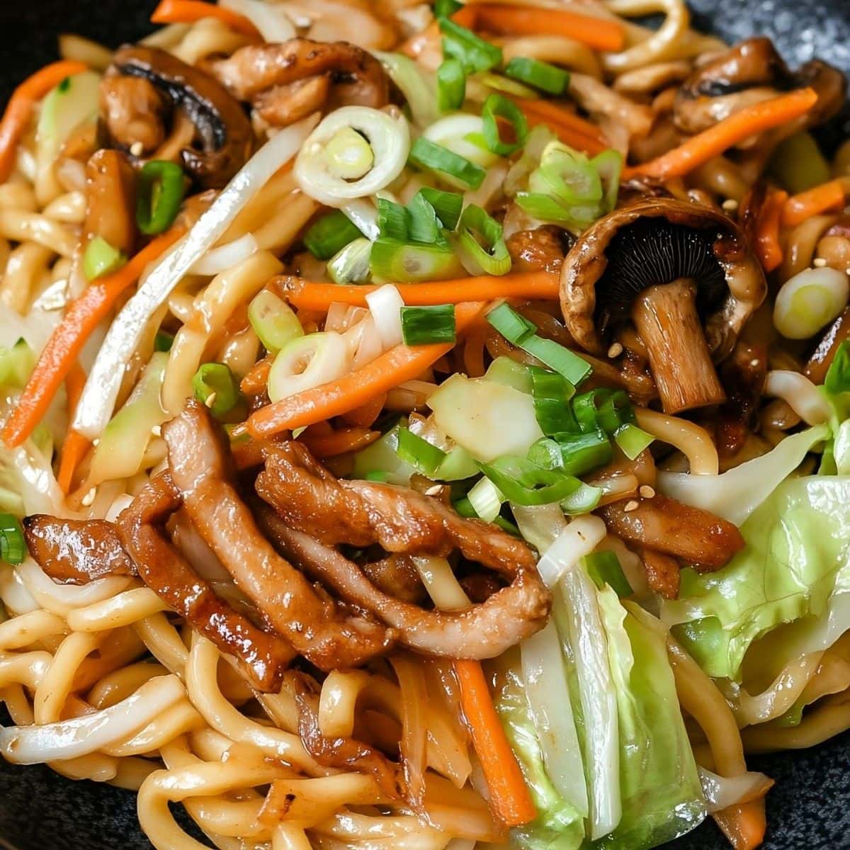 Yaki udon tossed in a skillet pan.