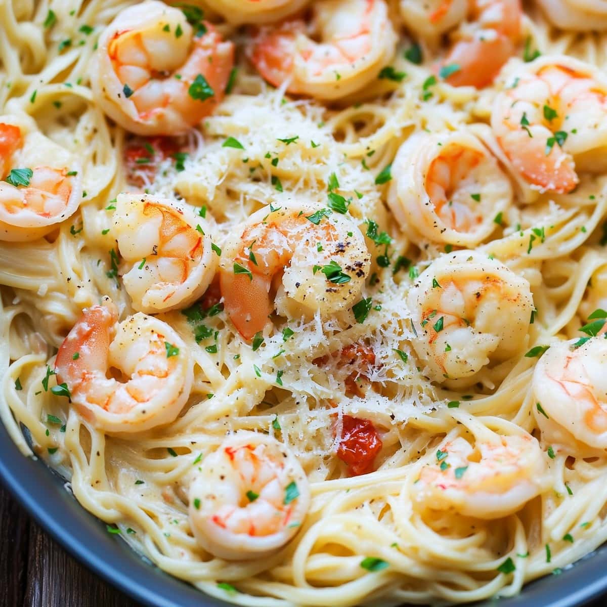 Angled hair pasta with creamy sauce and shrimp in a skillet pan.