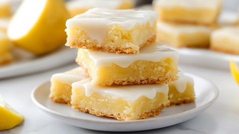 Sliced lemon brownies in a white plate.