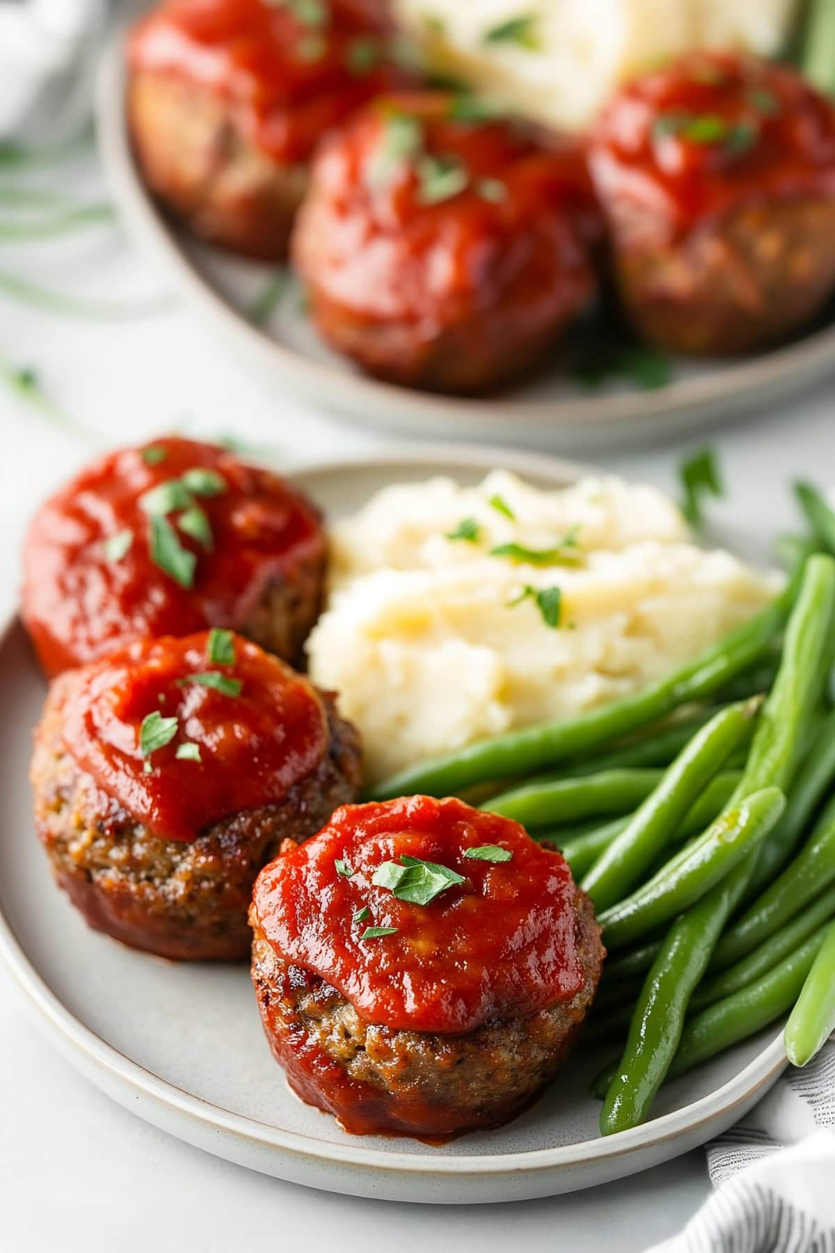 Two servings of meatloaf muffins in a plate.