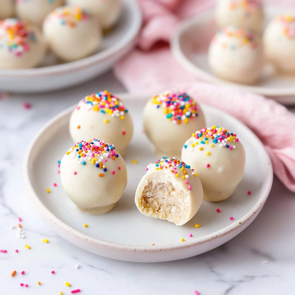 Sugar cookie truffles served on a white plate with spinkles