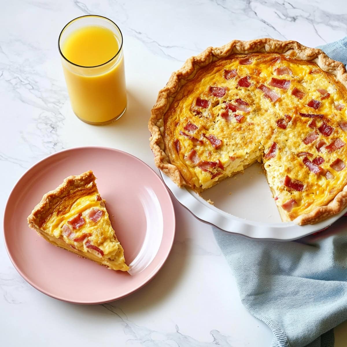 A slice of bacon and cheese on a pink plate with the rest of the quiche on the side. 