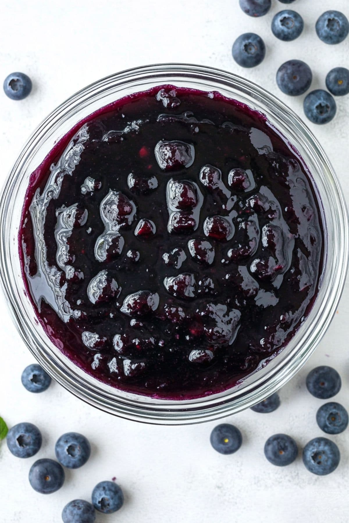 Blueberry pie filling in a glass bowl, top view