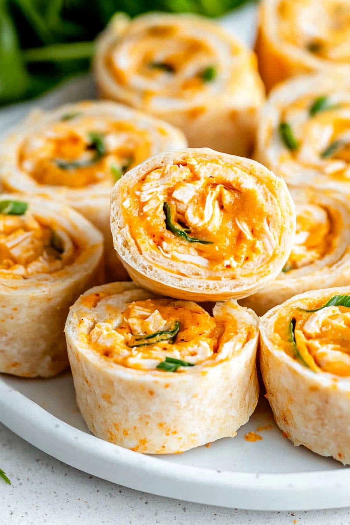 A plate full of buffalo chicken pinwheels, close up