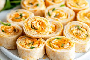 Sliced buffalo chicken pinwheels in a white plate.