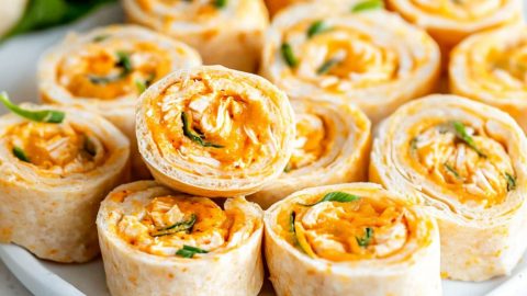 Sliced buffalo chicken pinwheels in a white plate.